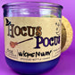 Purple glass candle jar with kraft label reading Hocus Pocus and WicksNWax