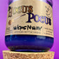 Purple glass candle with cork base, kraft label and WicksNWax Hocus Pocus text