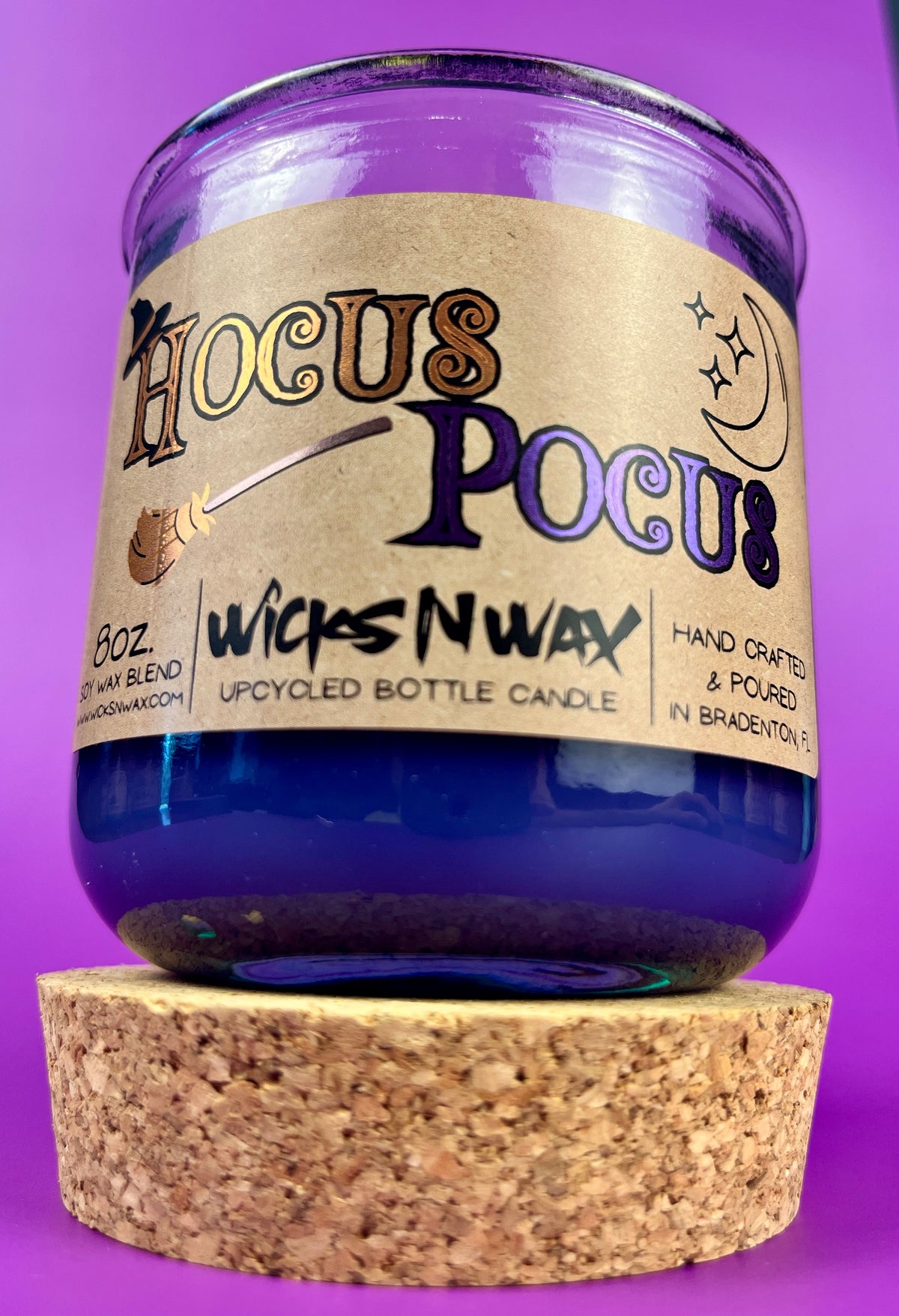 Purple glass candle with cork base, kraft label and WicksNWax Hocus Pocus text