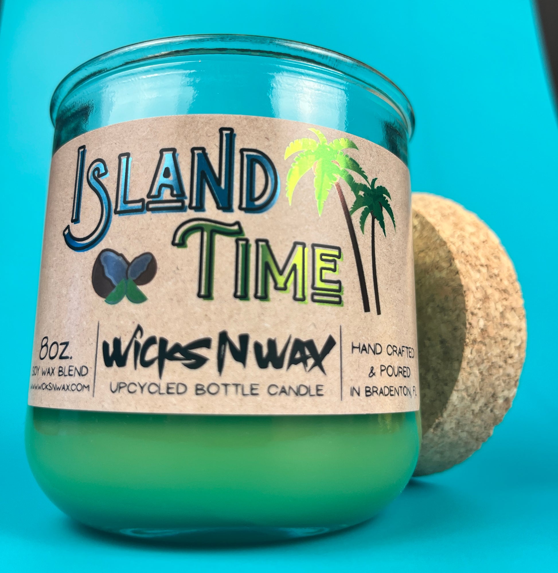 Recycled glass candle in teal jar with Island Time label, palm trees and butterfly
