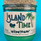 Recycled glass bottle candle with green wax and cork lid, teal glass jar with front branding.