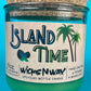 Recycled glass candle with green wax in jar, cork lid, island-themed label and WicksNWax text.