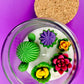 Large cactus art candle with green cactus wax, purple star flower, and rose flower cluster