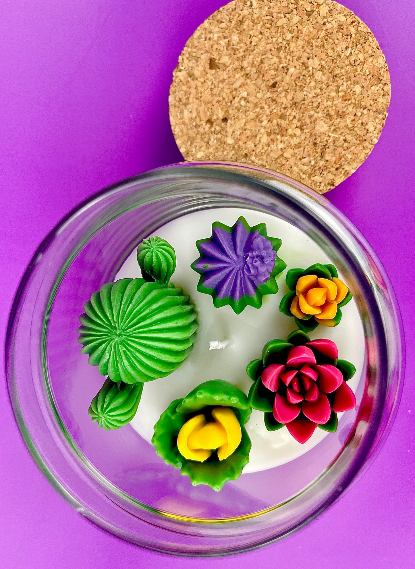 Large cactus art candle with green cactus wax, purple star flower, and rose flower cluster