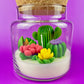 Cactus art candle with clear jar and cork lid; white wax with green cactus and yellow flower