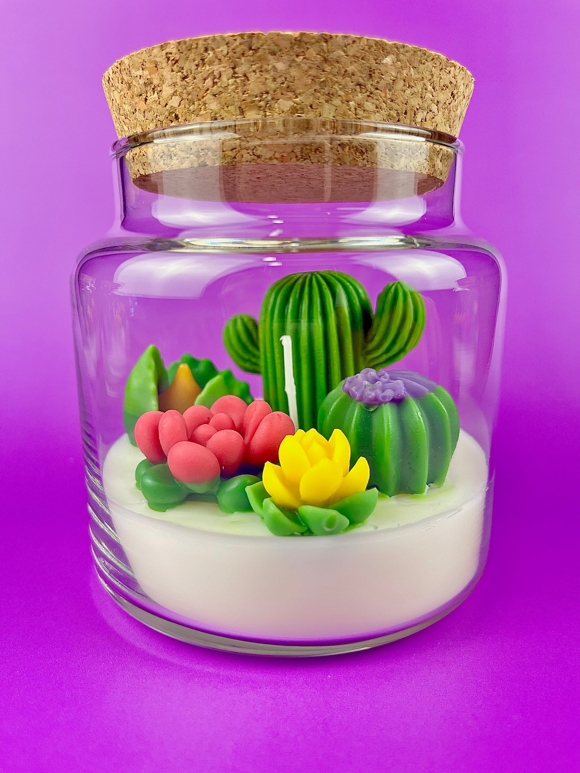 Cactus art candle with clear jar and cork lid; white wax with green cactus and yellow flower