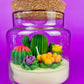 Cactus art candle with clear glass jar, cork top, white wax and colorful cactus accents
