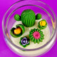 Cactus art candle with white wax and green cactus flowers in a clear round jar
