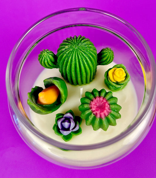Cactus art candle with white wax and green cactus flowers in a clear round jar