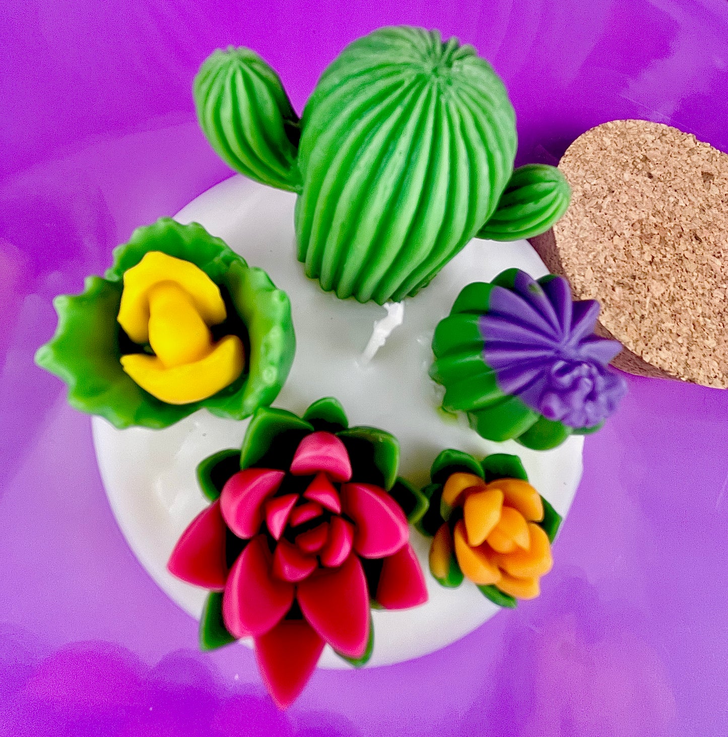 Large cactus art candle close-up with green cactus wax and colorful flower waxes in white wax