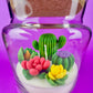 Large cactus art candle in glass jar with green cactus and pink, yellow, and purple flower waxes