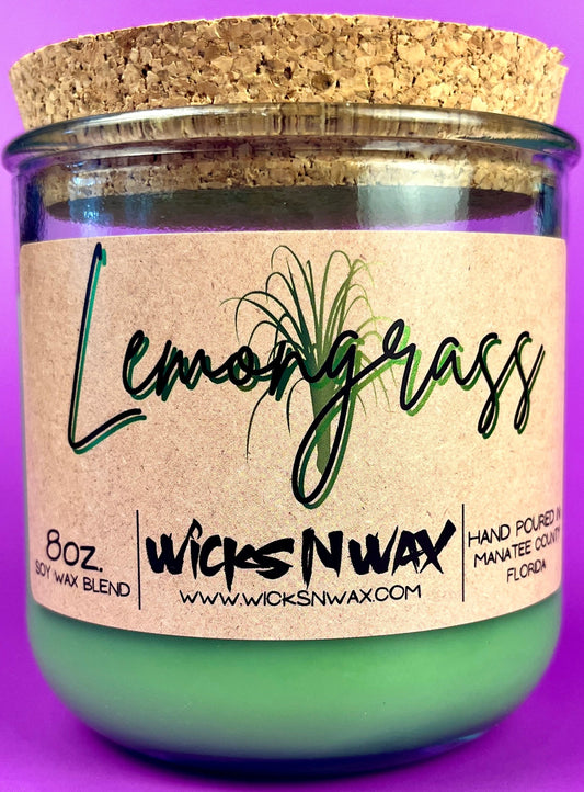 Recycled glass candle in clear jar with beige label and green lemongrass script