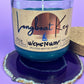 Recycled glass candle in blue wax, on glittery coaster, cork lid behind jar