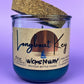Recycled glass candle in blue wax, cork lid on top, jar front label visible