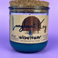 Recycled glass candle in blue wax, cork lid on top, front label and wick icon