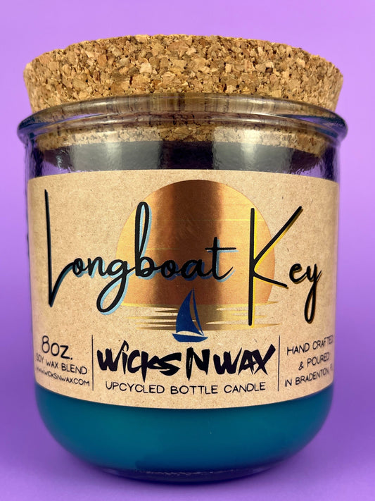 Recycled glass candle in blue jar with cork lid and WicksNWax label