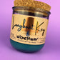 Recycled glass candle in blue wax, cork lid on top, round jar with front label
