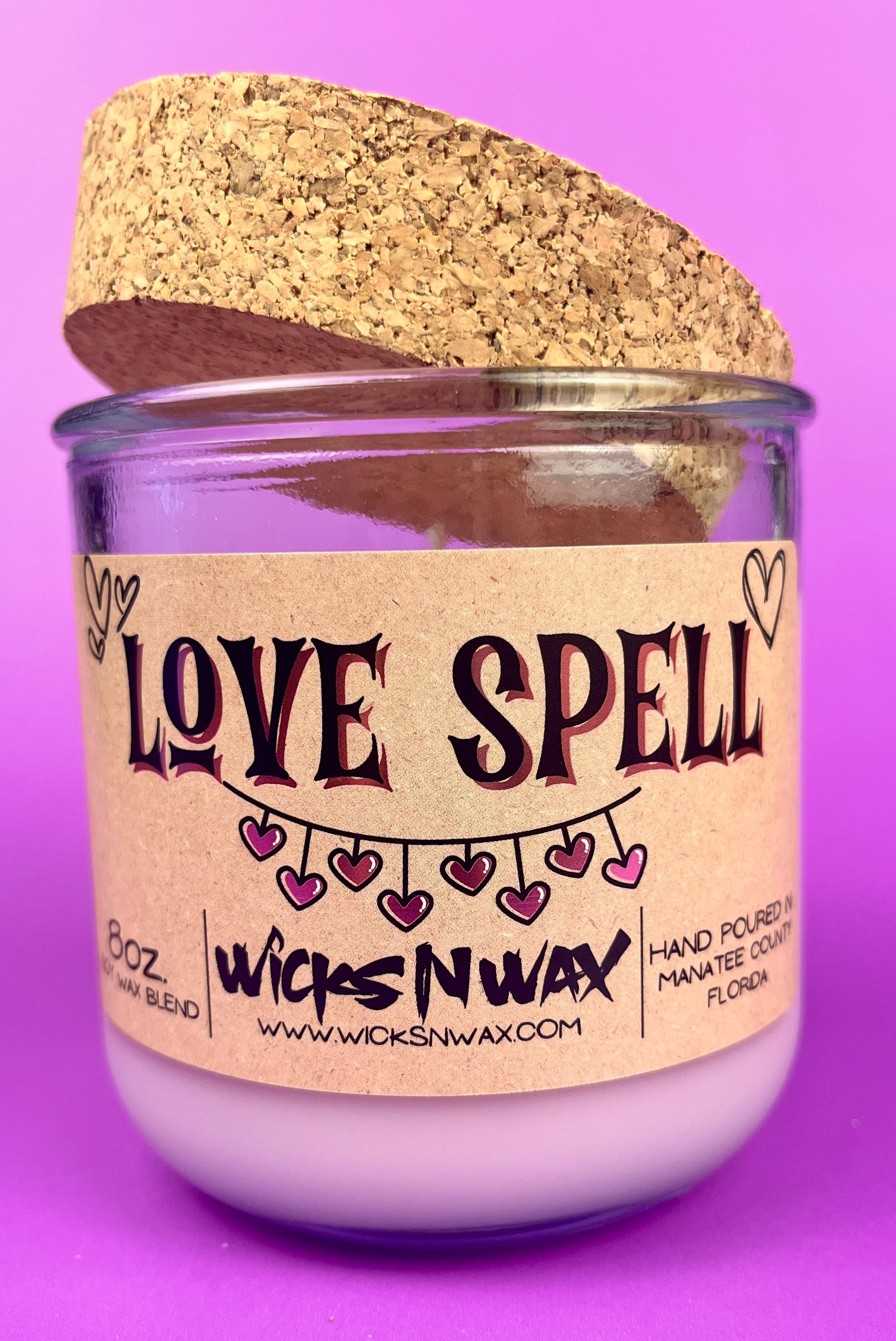 Recycled glass candle, purple jar with cork lid; beige 'LOVE SPELL' label on front