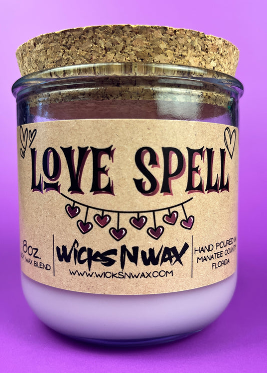 Recycled glass candle in purple glass with cork lid and beige 'LOVE SPELL' label