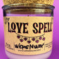 Recycled glass candle in purple glass with cork lid; beige label says 'LOVE SPELL'