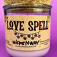 Recycled glass candle in purple glass with cork lid; beige label says 'LOVE SPELL'