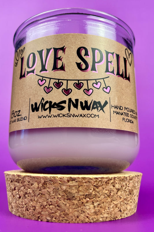 Recycled glass Love Spell candle with kraft label, hearts, and wide top view