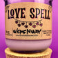 Recycled glass candle in a purple jar with cork lid; beige 'LOVE SPELL' label front
