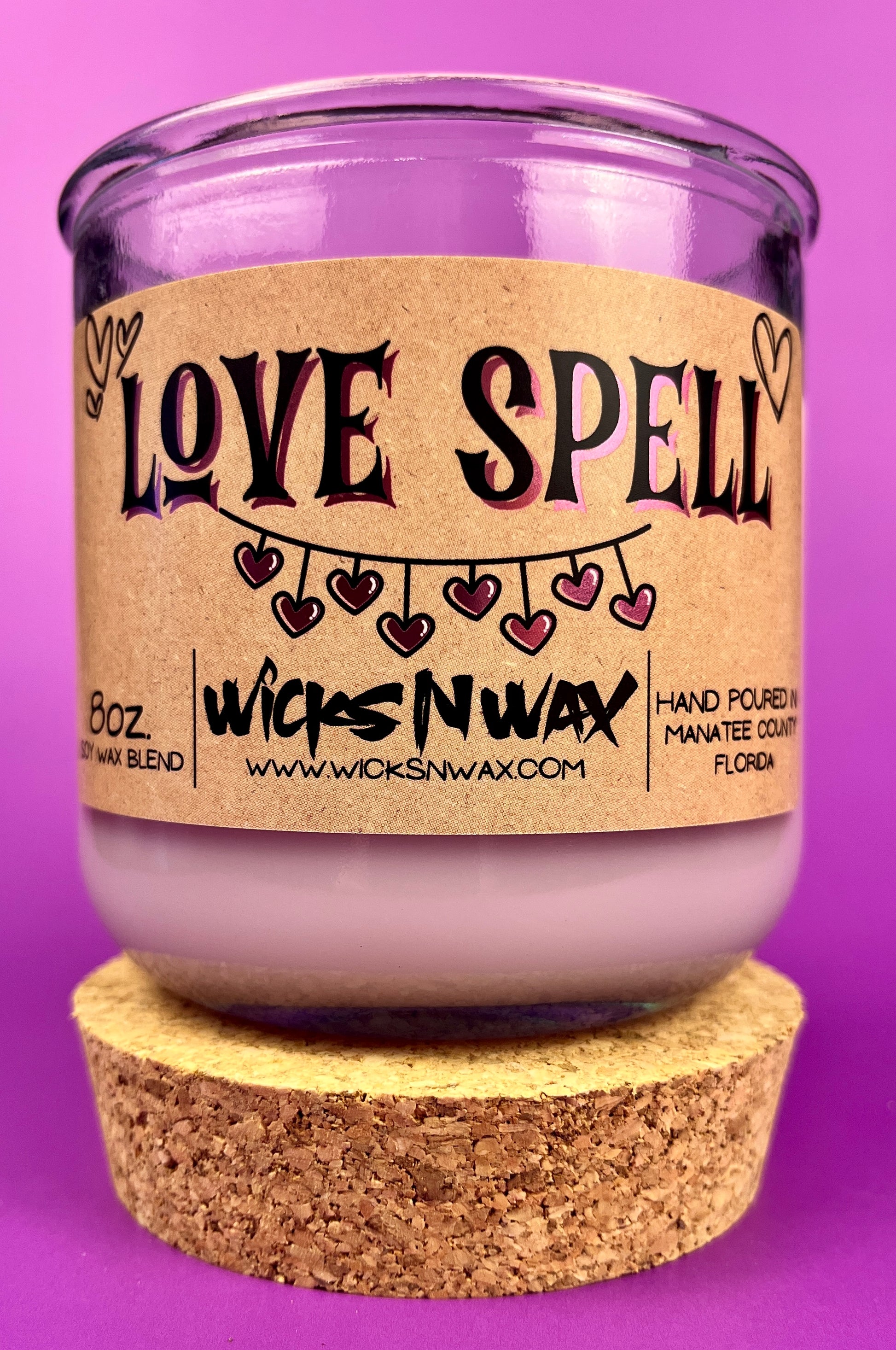 Recycled glass candle in a purple jar with cork lid; beige 'LOVE SPELL' label front
