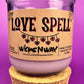 Recycled glass candle, purple jar with cork lid; beige label says 'LOVE SPELL'
