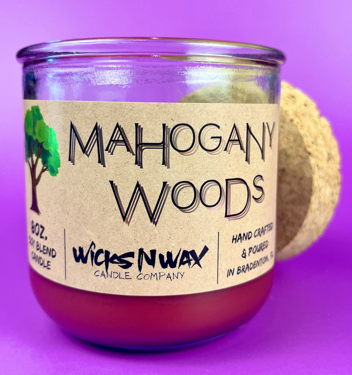 Recycled glass candle jar, cork lid with purple wax; label details visible.