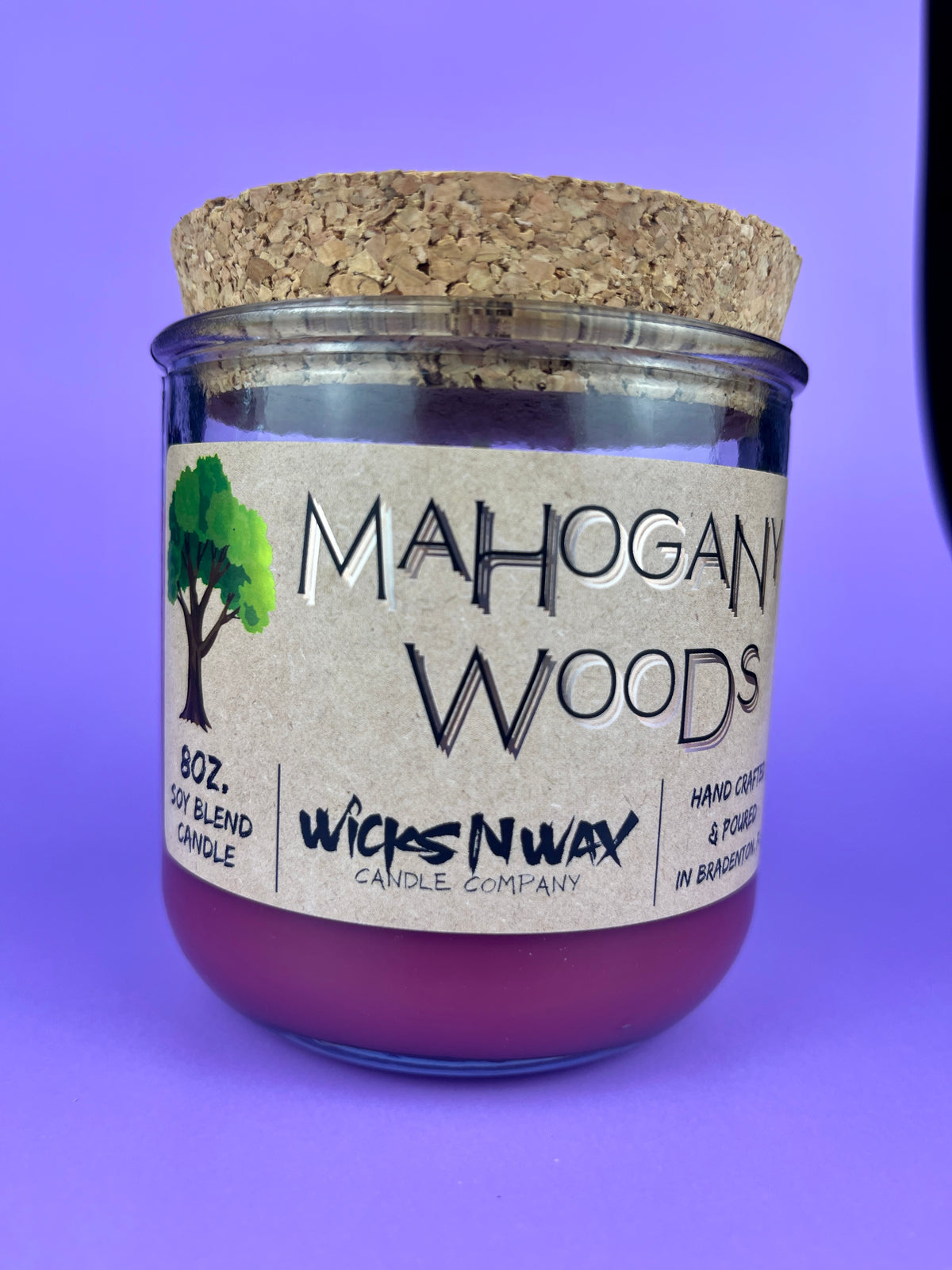 Recycled glass candle jar with cork lid, purple wax, WicksNWax label centered.