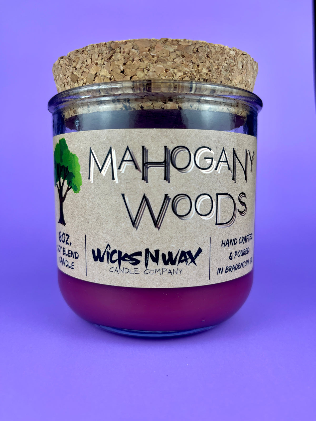 Recycled glass candle jar with cork lid, purple wax, WicksNWax logo and label.