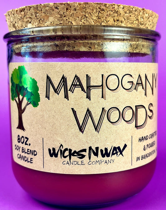Recycled glass candle with silver lid and kraft label reading Mahogany Woods