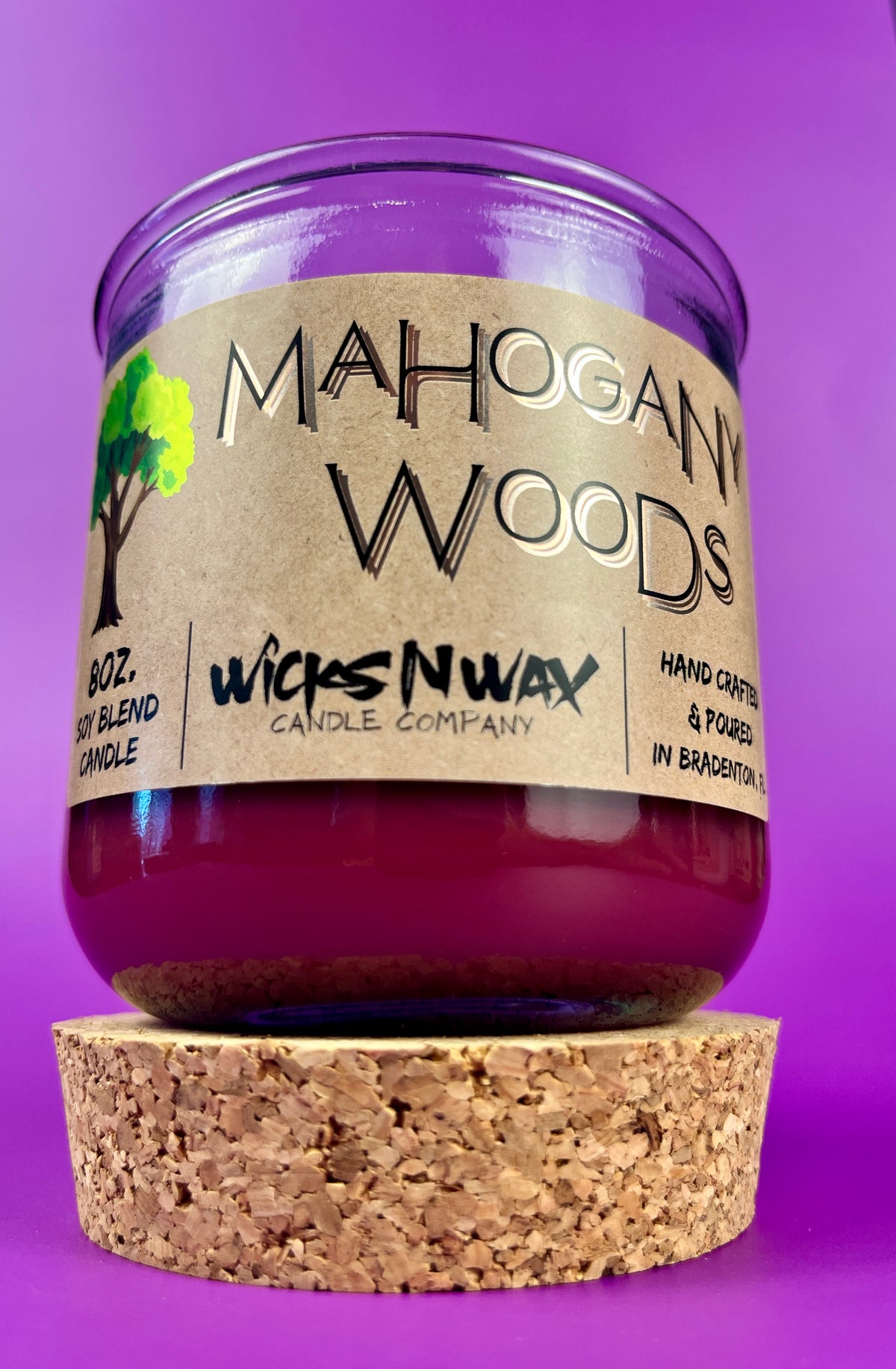 Recycled glass candle with cork lid and purple wax; cork coaster base shown.