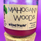 Recycled glass candle with cork lid, purple wax, label facing forward; cork base visible.