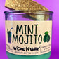Recycled glass candle with mint-green wax, cork lid, label and fragrance icons visible