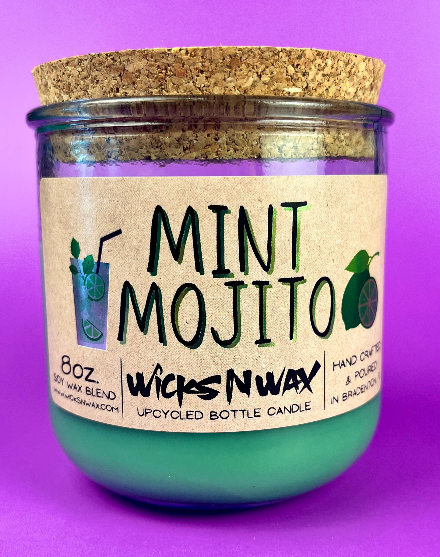 Recycled glass candle with mint-green wax, cork lid, label reading MINT MOJITO