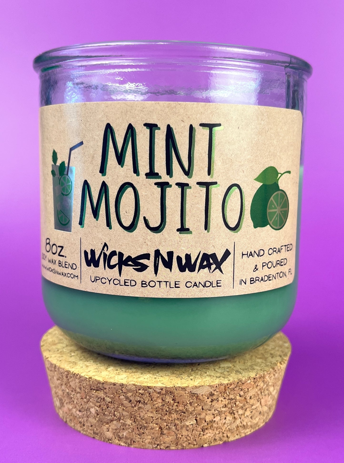 Recycled glass candle with mint-green wax, cork base, MINT MOJITO label and citrus icons