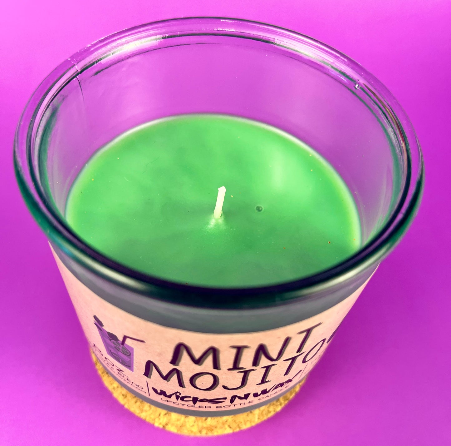 Mint-green candle in recycled glass jar, single wick centered, cork base visible