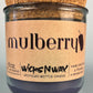 Mulberry WicksNWax upcycled bottle candle in clear glass jar, cork top visible