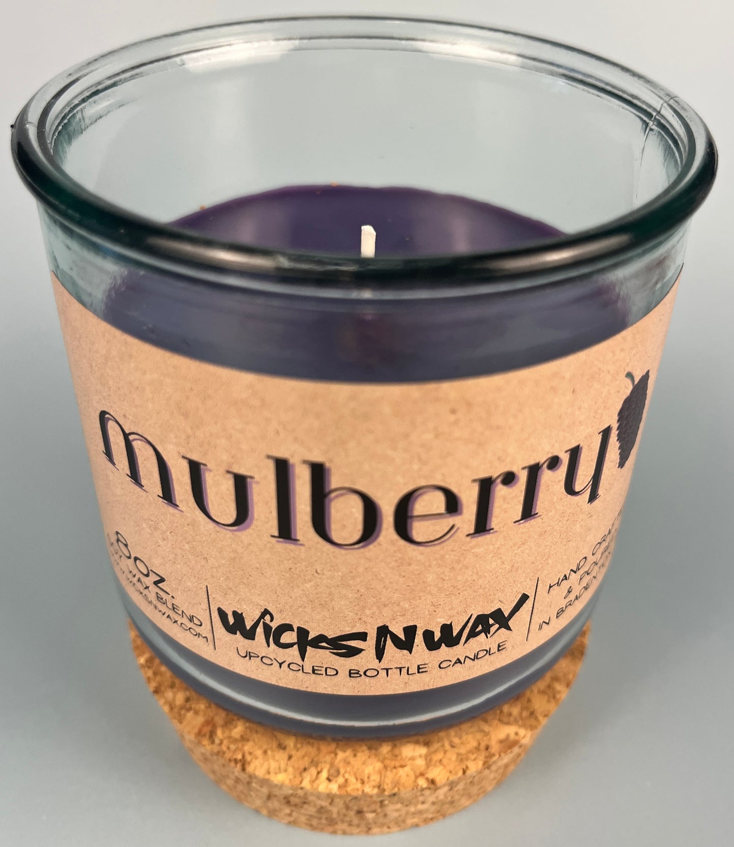 Mulberry WicksNWax upcycled bottle candle in clear glass jar, side label and dark wax