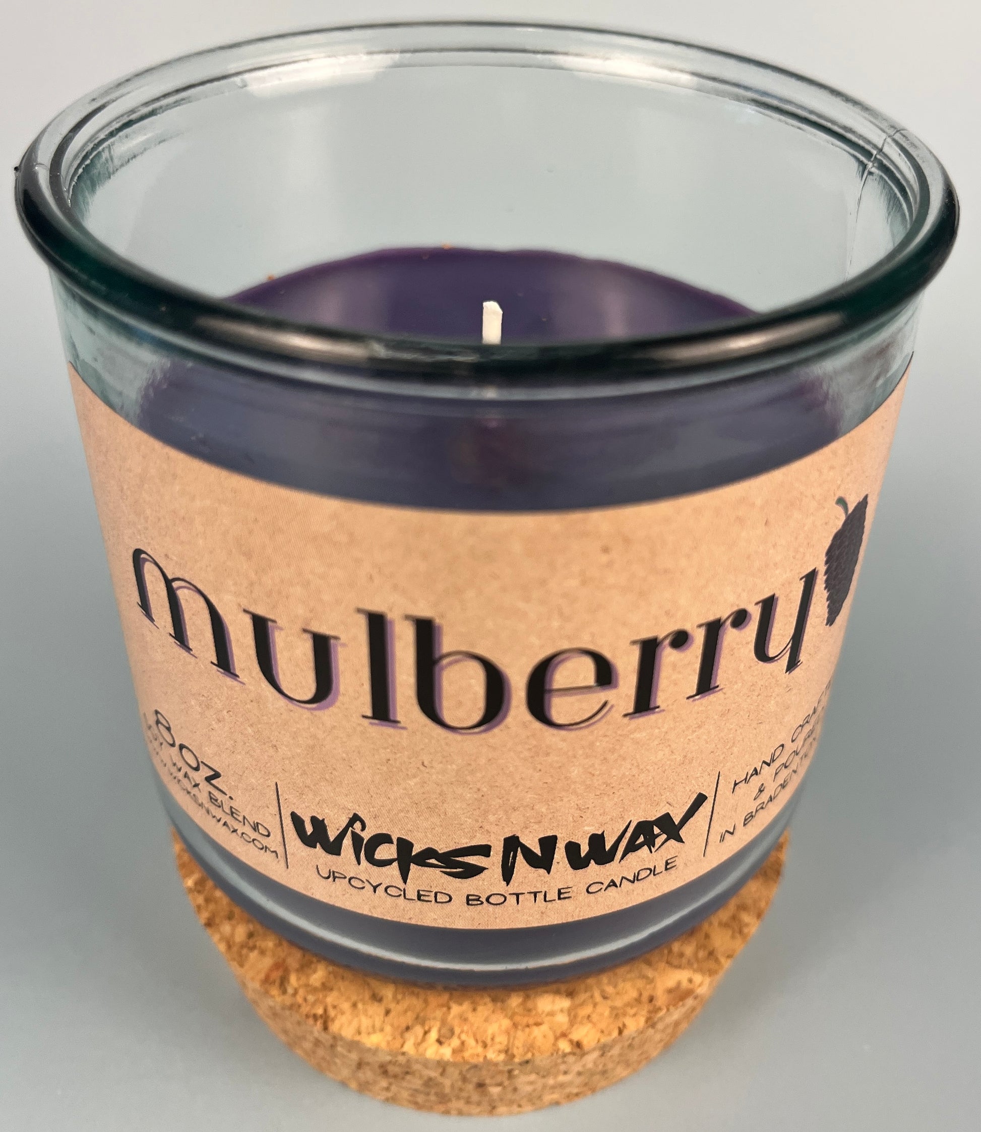 Mulberry WicksNWax upcycled bottle candle in clear glass jar, side label and dark wax
