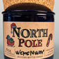 Blue glass candle jar on cork base with North Pole label and WicksNWax logo.