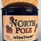 Blue glass candle on cork base with North Pole label, WicksNWax branding.