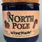 Blue glass candle jar with cork base and North Pole label, hand crafted text.