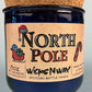 Blue glass candle jar with cork base, North Pole graphic label and 8 oz text.