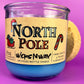Recycled bottle candle with blue wax and kraft label on purple-tinted glass jar
