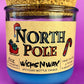 Recycled bottle candle with blue wax and kraft label; cork base visible