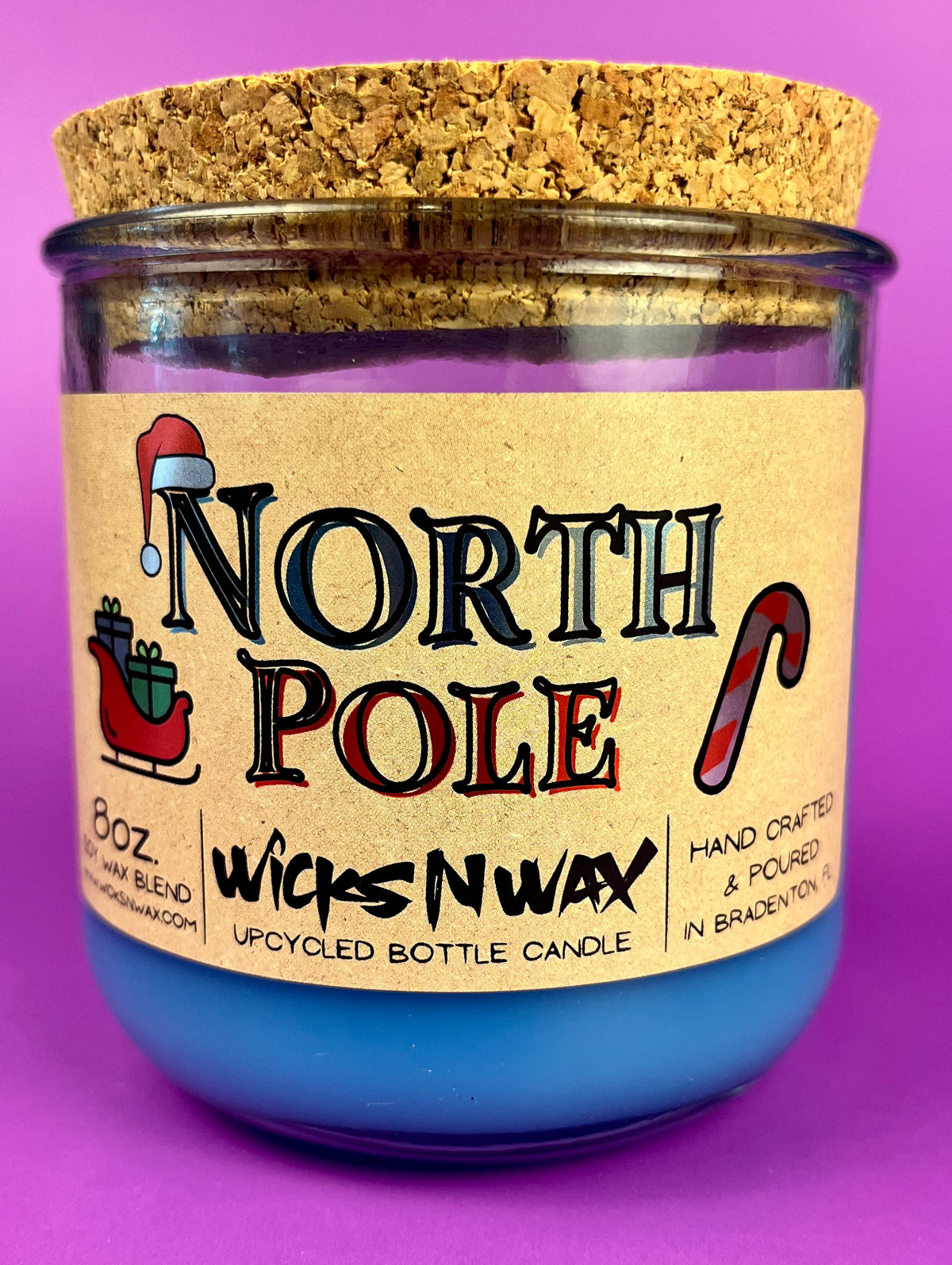 Recycled bottle candle with blue wax, kraft label, and cork coaster