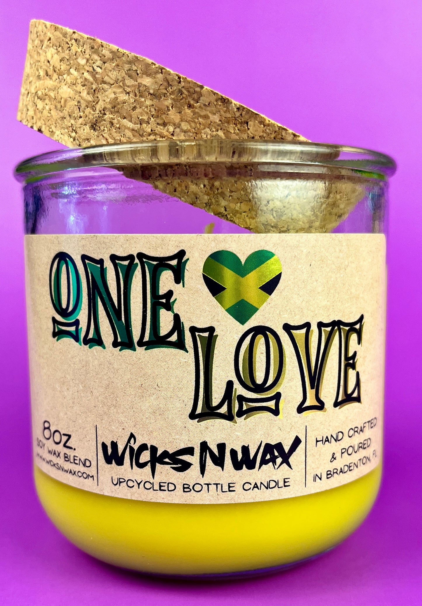 Recycled glass candle in amber jar with cork insert, yellow wax, One Love label.